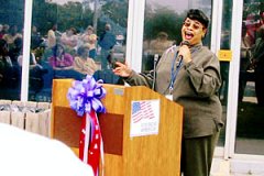 [Photo 2: Vettra Williams sings outside the HUD KS/MO State Office's building at their local Oklahoma City Memorial.]