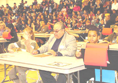 [Photo 2: FOD Miguel Rincon reviewing contestant score sheets]