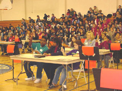 [Photo 4: Judges and participants listening to instructions]