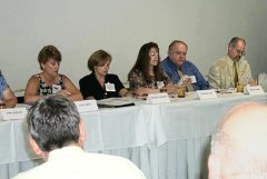 [Photo 1: HUD staff members at the workshop] 