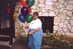 [Photo 1: A fair organizer sets up balloons outside the entrance to Shiloh Missionary Baptist Church.]