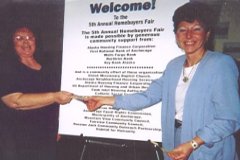[Photo 2: The lucky winner of the $200 gift certificate claims her prize.]