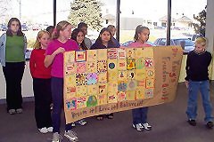 [Photo 3:  Students made a paper quilt with individual quilt pieces and their signed names]