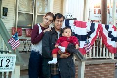 [Photo 1: Juan, Jennifer, and Josie in front of their new home.]