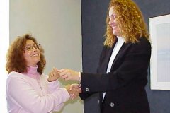 [Photo 2: Pat Carper gives Amelia Miller the keys to her new home.]