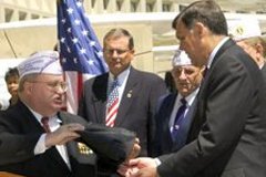 [Photo 4: William Pittman presents a POW-MIA flag to Secretary Martinez]