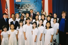 [Secretary Martinez with the World Children's Choir.  The children sang and entertained the large crowd of HUD employees before President George W. Bush addressed HUD employees.]