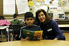 [Photo: Patti Zigler works on reading skills with a student.]
