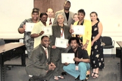 [Photo: The first graduates of the Homebuyer Education Class holding their certificates of completion.]