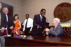 [Photo 2: The Governor of South Carolina gives a copy of his proclamation to the HUD office director.]