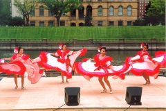 [Photo 1: Folkloric dancers in red and white costumes.]