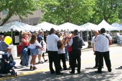 [Photo 2: A mariachi band serenades the festival attendees.]