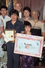 [Photo 1: The Fong family with Dan Stotmeister and Georgina Taylor.]