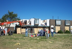 [Photo: Repairing and rebuilding the Amber Woods Apartments.]