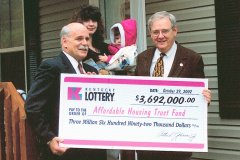 [Photo 1: Arch Gleason and Lynn Luallen present a check for $3,692,000.]