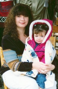 [Photo 2: Ms. McGlone sits with her child Haley on her lap.]