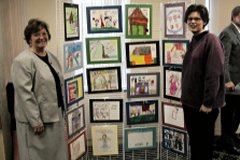 [Photo 3: Paintings and drawings on display between OACCH Co-Chairs Sue Maiwald and Sherry Glasnapp.]