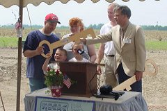 [Photo 2: A Missouri family receives the keys to their new home.]