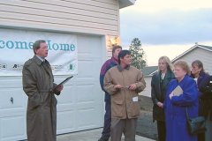 [Photo 2: Partnership officials at the new home ceremony]
