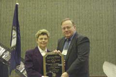Photo: Director Ben Cook presents award to Director Nancy Shelton