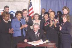 [Photo: Governor Paul Patton signing in the Capitol Rotunda April 8.]
