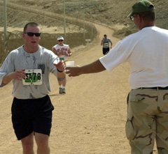 [Photo 2:  Runners getting water]