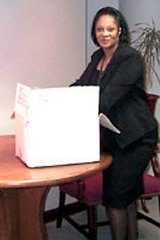 [Photo: Donna Armstrong happily wrapping a care package]