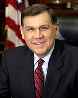[Photo 1: Picture of Secretary Martinez with the American flag in the background]