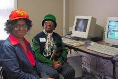 [Photo 1: Mrs. Daugherty and Mrs. Butts sitting in front of the computers]