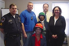 [Photo 2: Police officers with staff and members of St. William Apartments]