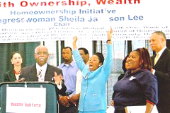 [Photo 2: With arms outstretched, Congresswoman Lee cheers on while Mr. Babers addresses the crowd at the podium] 