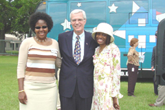 [Photo: Assistant Secretary Bernardi with two new homeowners]