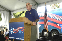 [Photo: Orange County Chairman speaking at the podium]