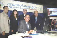 [Photo 1: Secretary Martinez surfs the website as LULAC officials look on]