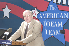 [Photo 1: Commissioner John Weicher at the microphone]