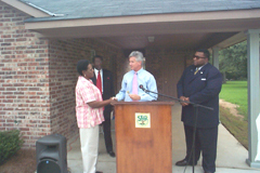 [Photo: Zella Reliford receiving the keys to her new home]