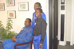 [Photo 1: Curtis sitting, Michelle and son Antoine Lee standing behind him]