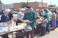 [Photo 1: Recipients receiving free food]