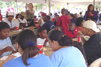 [Photo 2: People sitting at tables eating]