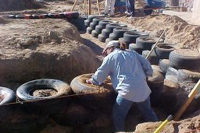 [Photo 2: A woman learning construction skills while building the Center]
