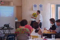 [Photo 3: View of FHEO Director Roybal and trainees in a classroom setting]