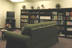 [Photo 3: Bookshelves, TV and couch]