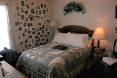 [Photo 4: Quilt hanging on the bedroom wall]