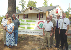 [Photo: New homeowner and Habitat partners]