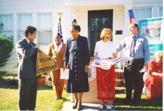 [Photo 3: Mrs. Coleman surrounded by dignitaries]
