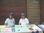 [Photo 3: Livingston and Buchanan handing out information in home buying]