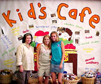 [Photo 1: Kid's Caf� program director with teen volunteers]