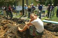 [Photo 1: Volunteers taking a break from digging]