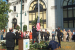 [Photo 1: Director Stephen Banko looking on the flag raising]