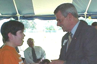 [Photo 1: Lt. Gov. Win Rockefeller presenting a key to Susan Tobin]